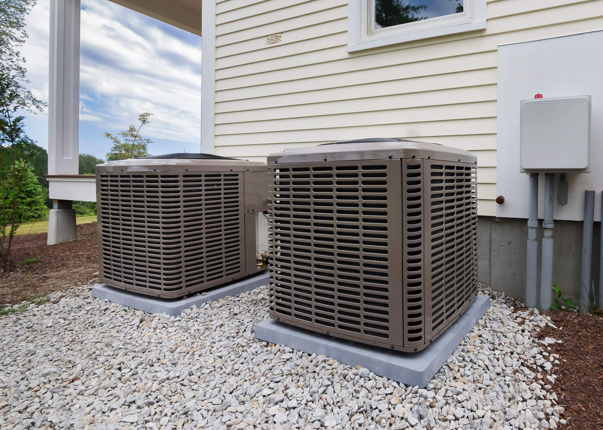 Two air conditioning units outside of a home