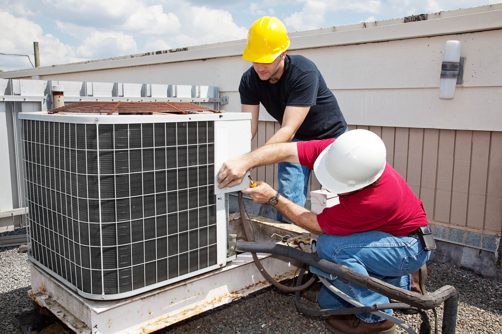 people installing an air conditioning unit